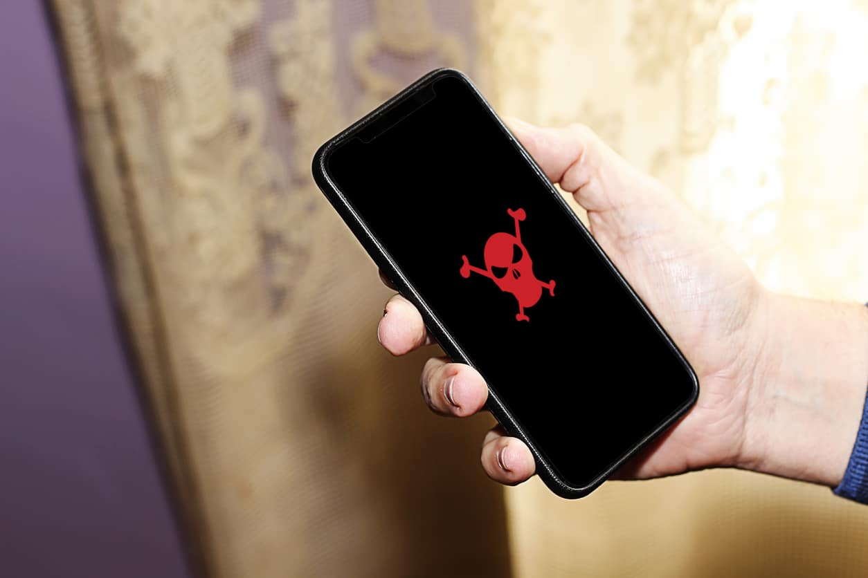 Red pirate skull on smart phone screen