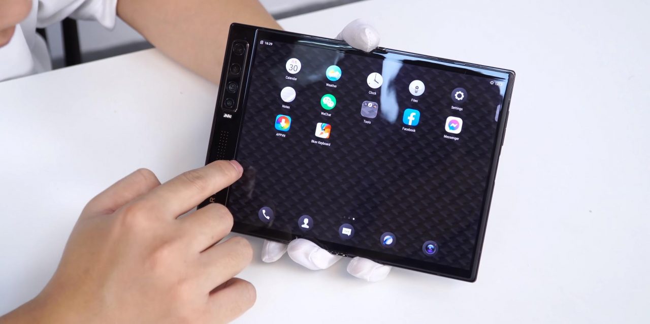 Mão segura o smartphone Vertu Ayxta Fold aberto
