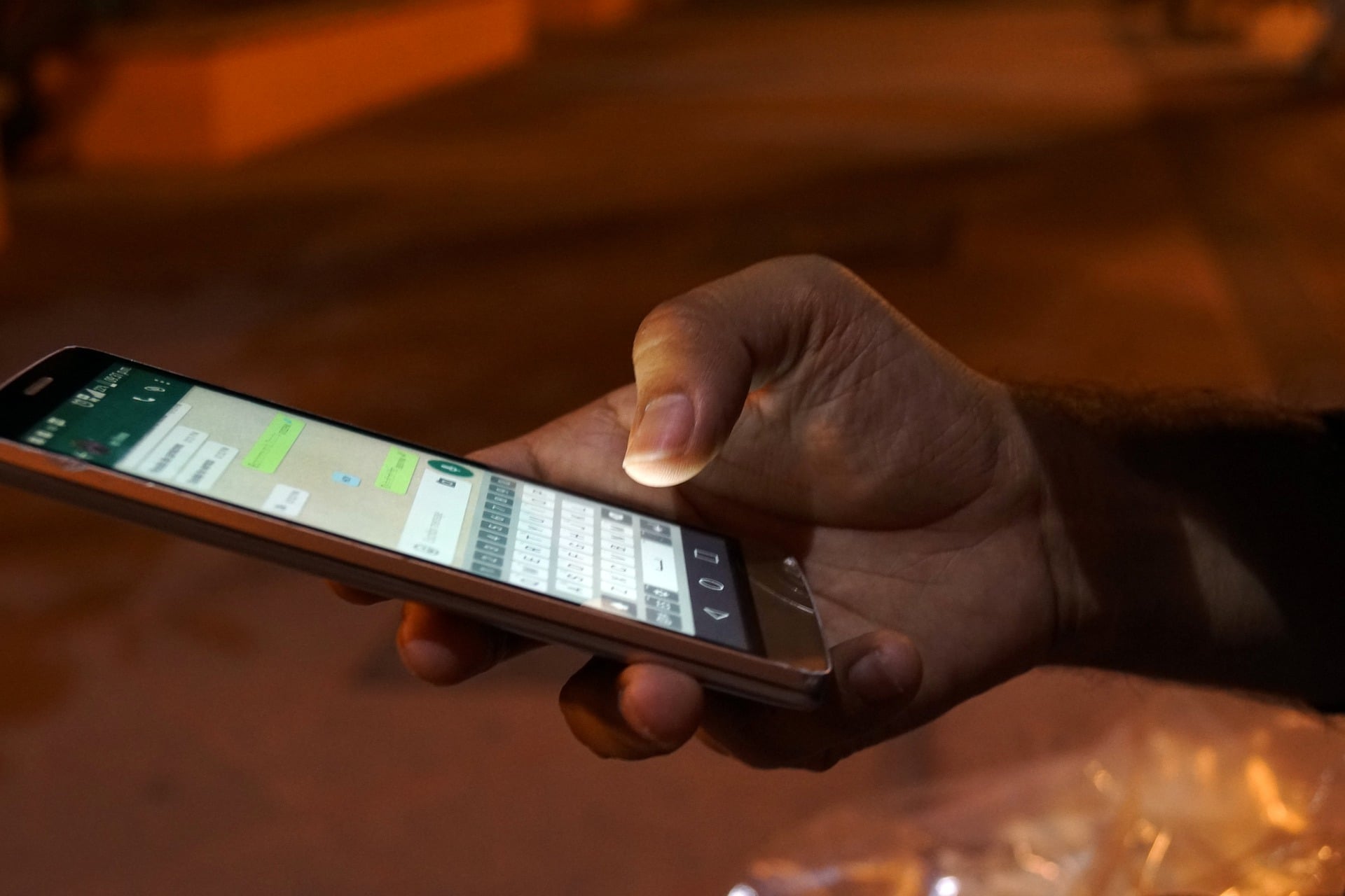 pessoa mexendo no WhatsApp em seu celular, que poderá ter a função de revisar mensagem de voz antes de envio